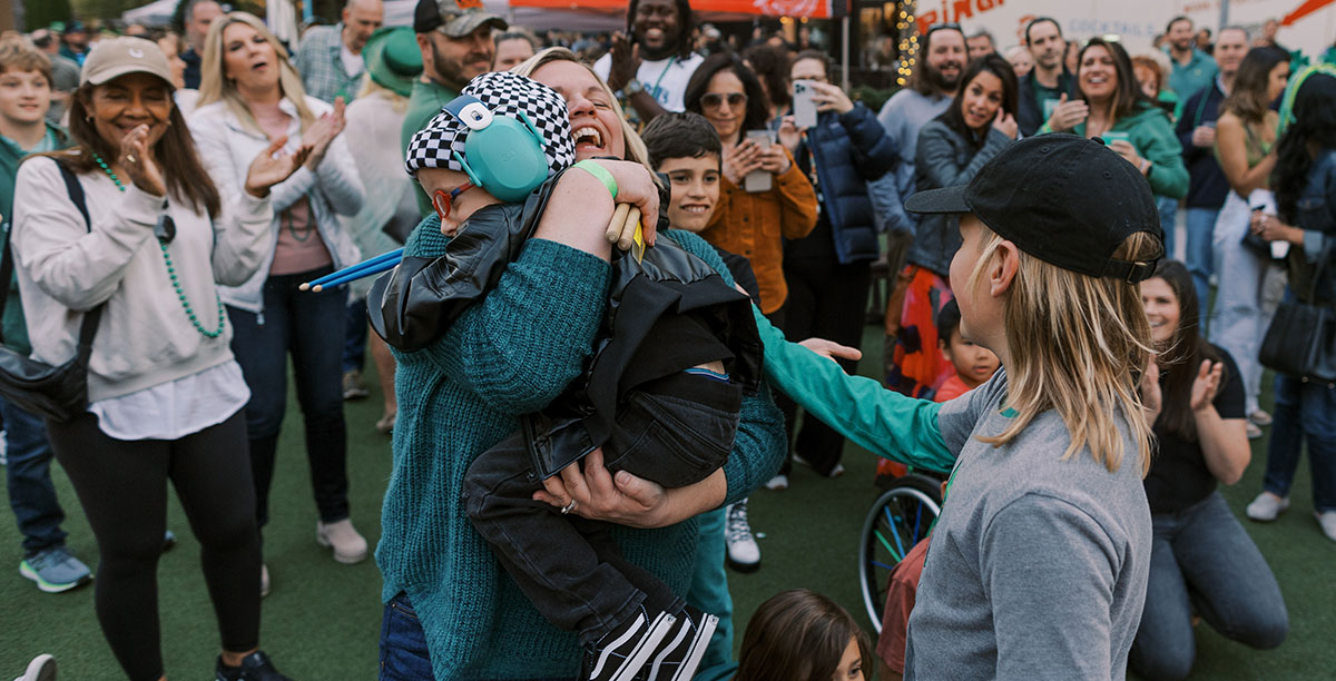 Jax's mom give him a hug after he plays drums live on stage!